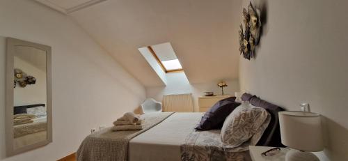 a bedroom with a bed in a white room at Junto a la Catedral in Burgos