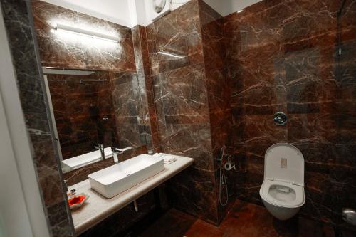 a bathroom with a sink and a toilet at Burj Baneria - A Boutique Homestay in Udaipur