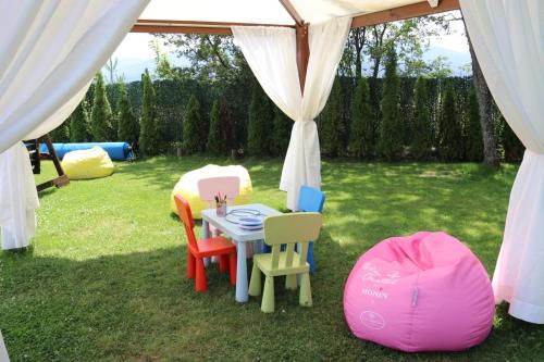a tent with chairs and a table in the grass at Belchin Garden SPA&Wellness in Belchin
