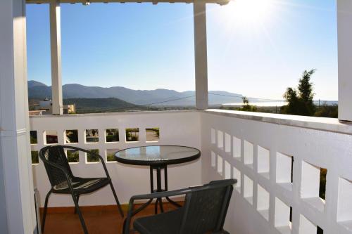 a table and chairs on a balcony with a view at Tarmaros - Families & Groups in Sissi