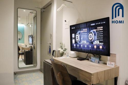 a tv on a wall in a room at Homi Breeze at Sutera Avenue 和逸微风 in Kota Kinabalu