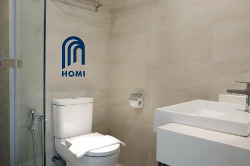 a bathroom with a toilet and a sink at Homi Breeze at Sutera Avenue 和逸微风 in Kota Kinabalu