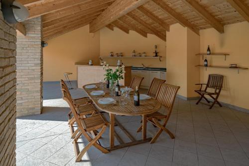 a dining room with a wooden table and chairs at Villa La Martina in Canelli