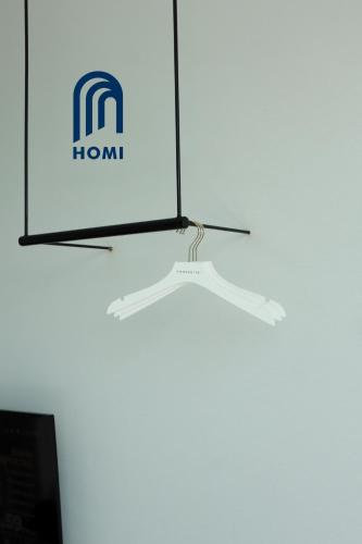 a hanging light in front of a white wall at Homi Breeze at Sutera Avenue 和逸微风 in Kota Kinabalu