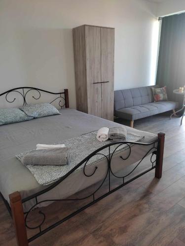 a bedroom with a bed and a couch at Villa Twins Dojran in Nov Dojran