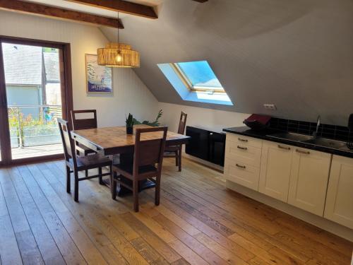 a kitchen with a table and chairs and a window at Les GITES DE CAMPARAN - gîte "le PETIT CHALET" in Camparan
