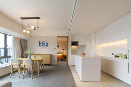 a kitchen and dining room with a table and chairs at Keypai Hotel Free Shuttle Bus to Canton Fair in Guangzhou