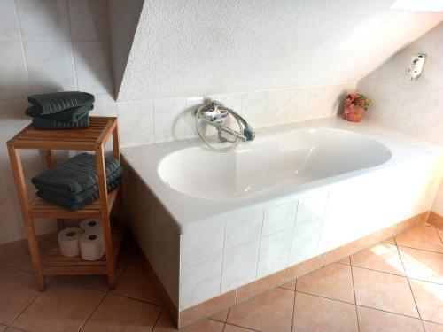 a bath tub with a faucet in a bathroom at Storchennest Spreewald in Vetschau
