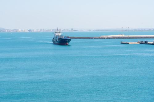 a boat in the middle of a large body of water at Plaza Mina Suites - Adults Recommended by Luxury Suites Cadiz in Cádiz