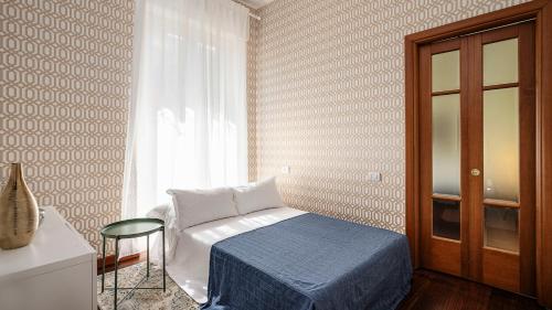 a small bedroom with a bed and a window at "Gold Fashion" - Residenza DUOMO Citylife in Milan