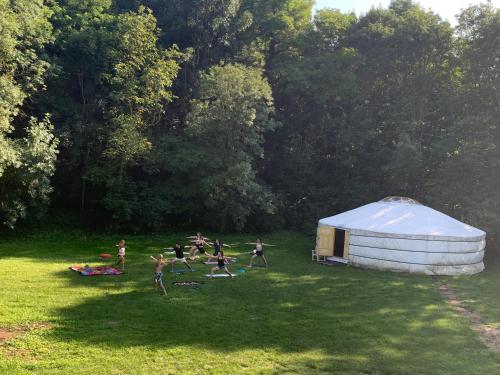 a group of children playing in a field next to a tent at Lélek-Tér in Siófok