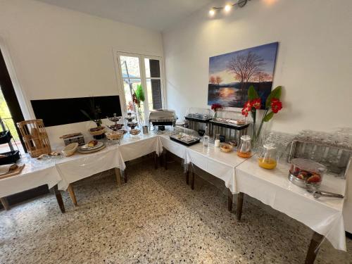 a dining room with white tables with food on them at Le Vaita in Porto Ota