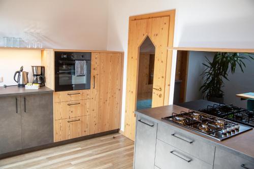 a kitchen with a stove and a counter top at Apt Lara Ruveda in Ortisei