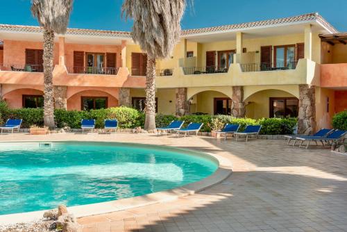 a resort with a swimming pool in front of a building at ISA-apartments with air conditioning and outdoor private space in residence with swimming-pool in Palau, only 150 meters from the sea in Palau