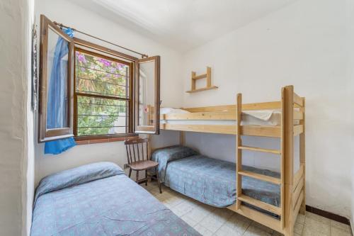 a bedroom with two bunk beds and a window at casa Camilla in Torre delle Stelle