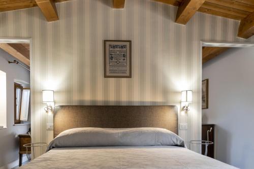 una camera con un grande letto con due lampade di La Foresteria di Serracavallo a Bisignano