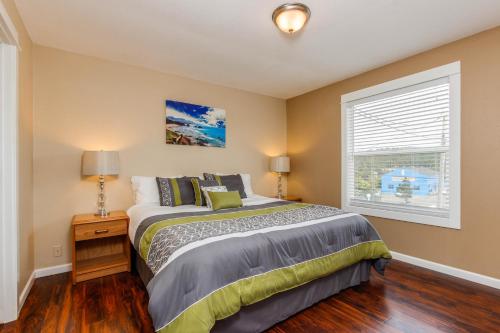 a bedroom with a bed and a window at The Whale in Lincoln City