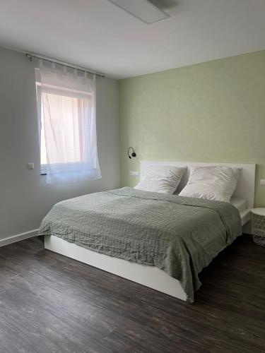 a bedroom with a large bed with a window at Loft am See in Dargun