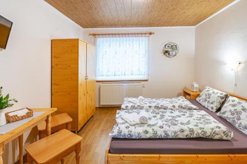 a bedroom with two beds and a window at Penzión Brest Habovka in Habovka