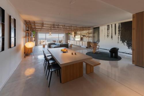 a living room with a table and chairs at Gozo Harbour Views, Mgarr Heights in Mġarr