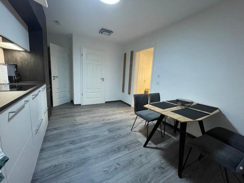 a kitchen with a table and a dining room at SWID Appartement 9 in Delitzsch