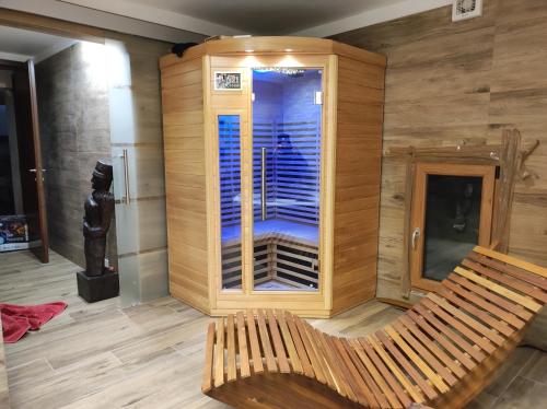 a wooden bench in a room with a sauna at Villa Quadrifoglio in Arenzano