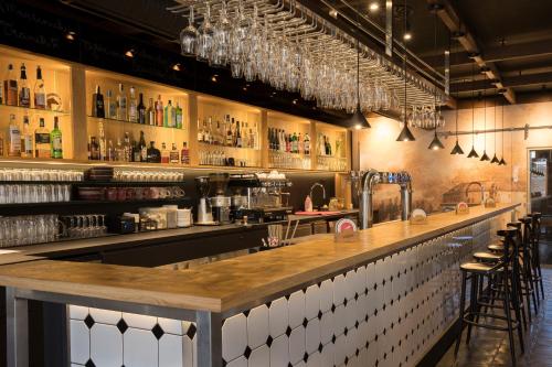 a bar with a wooden counter and some bottles at Equitana Hotel Resort in Březnice