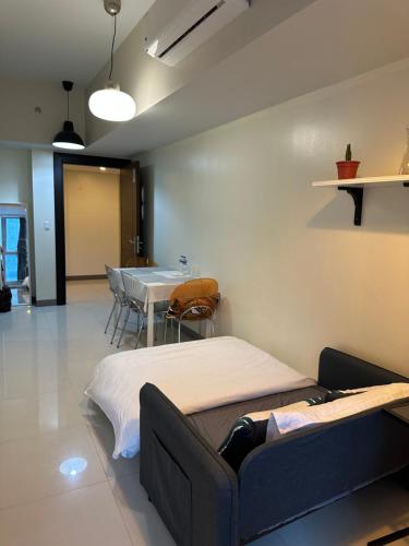 a hospital room with a bed and a table at One Uptown Residence - Thompson Suites in Manila