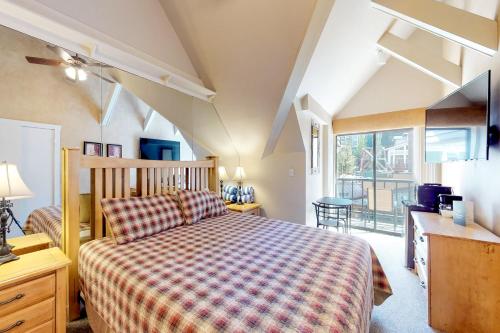 a bedroom with a bed and a desk and a window at The Lodge at Mountain Village Unit 308 A and B in Park City