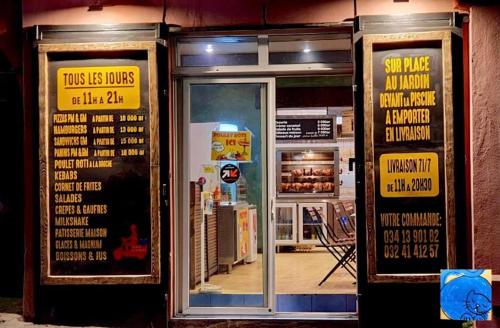 a store front with two doors with signs on them at Hotel Sakamanga in Antananarivo