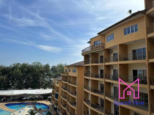 a large apartment building with a pool and a pink x at Gold Coast Morib Resort in Banting