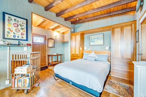 a bedroom with a bed and a crib in it at Headlands Cove - Retreat in Mendocino