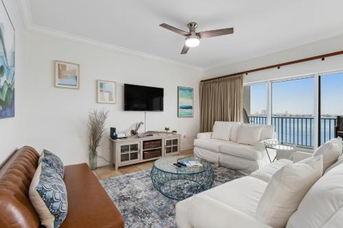 a living room with a couch and a tv at South Harbour 07B in Pensacola Beach