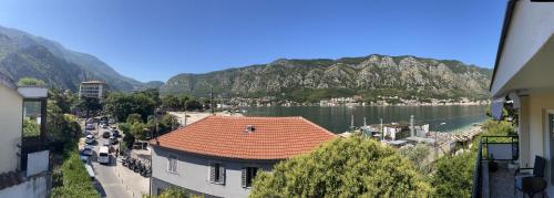 a view of a town with a river and mountains at Sea Breeze in Kotor