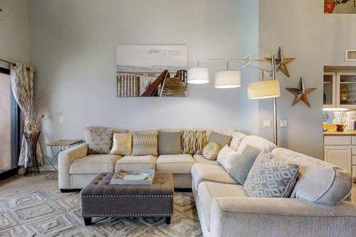 a living room with two couches and a table at Palm Beach Club 2-228 in Pensacola Beach
