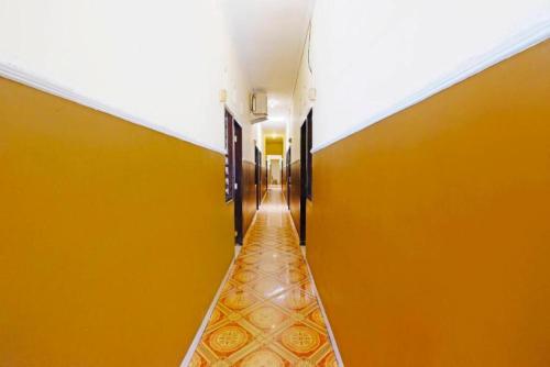 an empty hallway with orange walls and a long corridor at Wisma Idola Palopo in Palopo