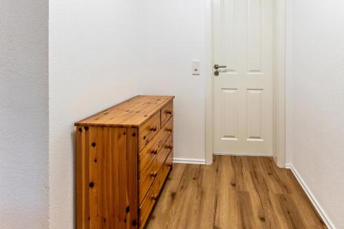 a wooden cabinet in a room with a door at Omas Obstkiste in Stockach