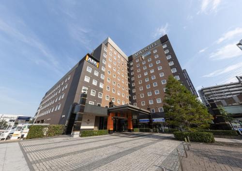 a large hotel building in a city at APA Hotel & Resort Tokyo Bay Shiomi in Tokyo