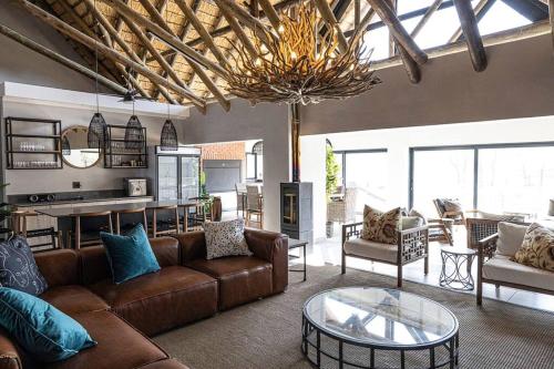 a living room with a couch and a table at The Fisherman's Cottage in Mooirivier