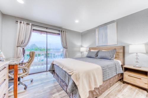 a bedroom with a bed and a desk and a window at Sea Treasures Inn #211 & #212 in Rockaway Beach