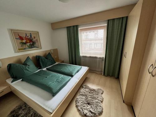1 dormitorio con 1 cama y 1 gato en el suelo en Haus Kneissl, en Seefeld in Tirol