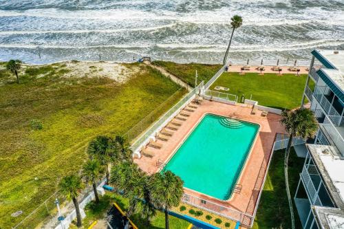 an overhead view of a swimming pool next to the ocean at Ocean Jewel Condos Unit 244 in Daytona Beach