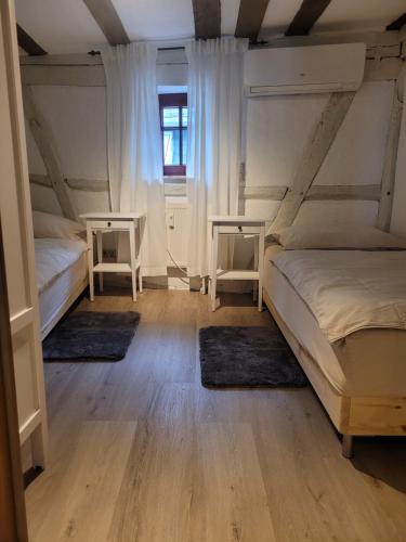 two beds in a room with two rugs at Ferienwohnung Kleine Rütsche in Limburg an der Lahn