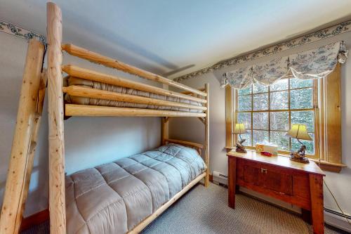 a bedroom with two bunk beds and a desk at Moose Lodge in Newry