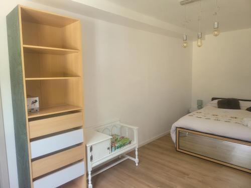 a small bedroom with a bed and a closet at Le Little cocoon in Durtol