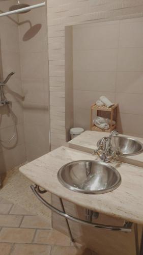 a bathroom with a sink and a shower at Hostal Poeta Machado in Baeza