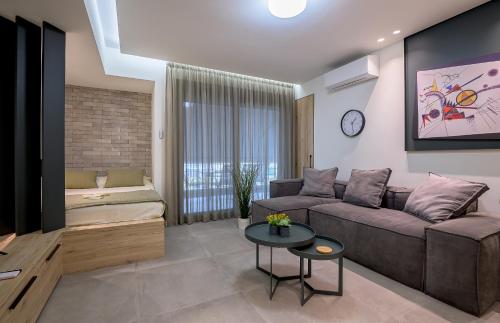 a living room with a couch and a table at ''THE 58 PROJECT'' in Alexandroupoli