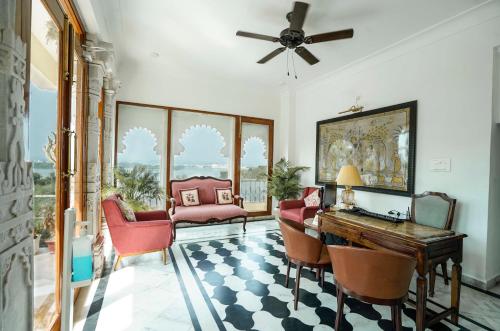 a living room with a desk and chairs at Burj Baneria - A Boutique Homestay in Udaipur