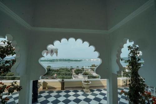 a room with a window with a view of the ocean at Burj Baneria - A Boutique Homestay in Udaipur