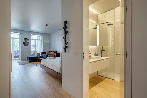 - une chambre avec un lit et une salle de bains pourvue d'un lavabo dans l'établissement Nomads Lux - 1BDR Almada Cool, à Porto